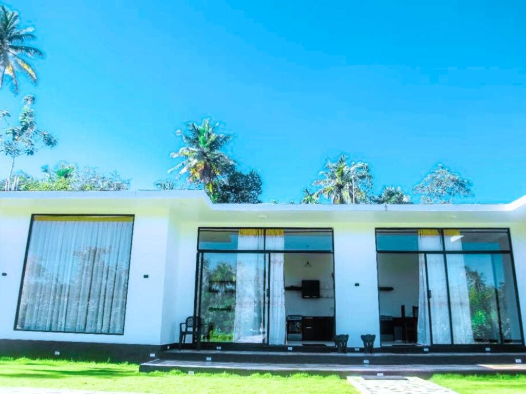 Garden suite exterior with large windows and palm trees